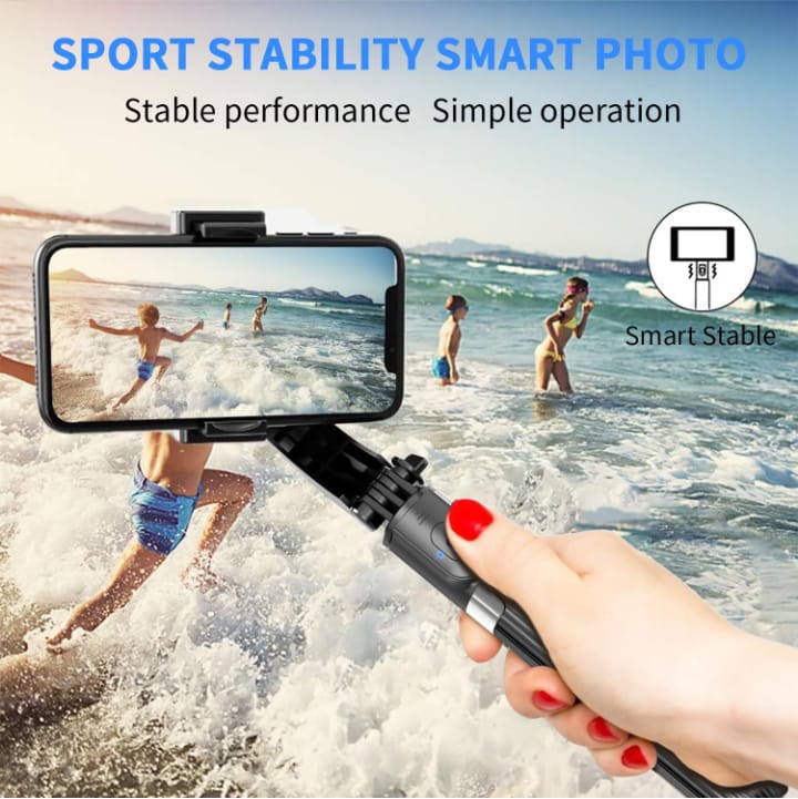 Hand holding a smartphone stabilizer with a beach scene on screen, showing 'Sport Stability Smart Photo' feature.