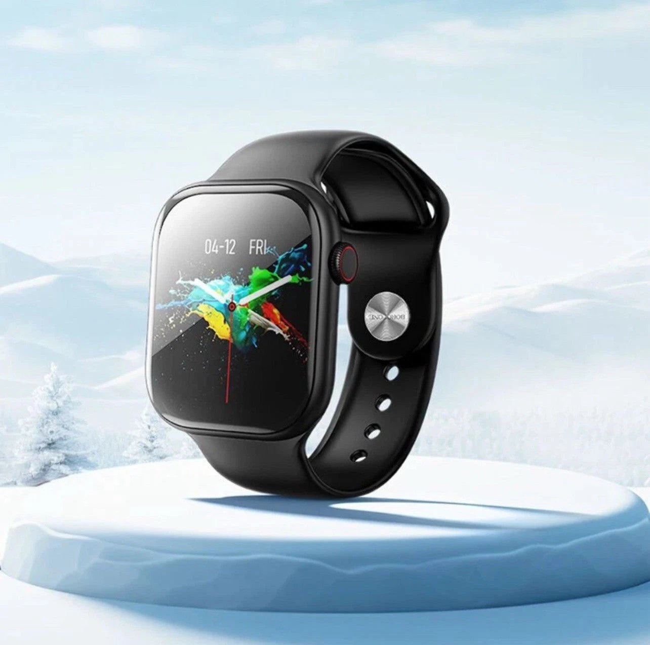 Black smartwatch on a white platform with a snowy landscape background